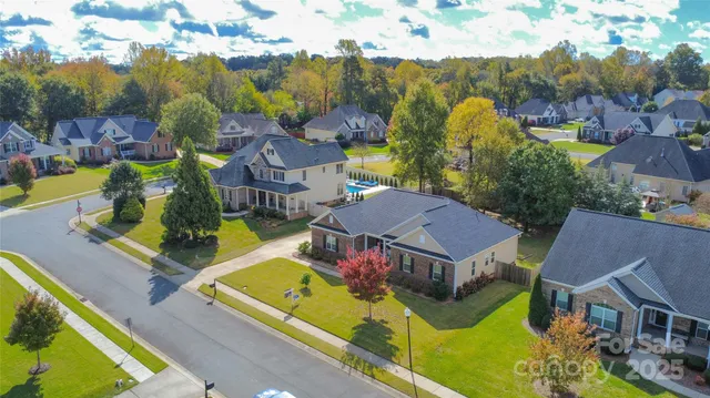 an aerial view of residential houses with yard