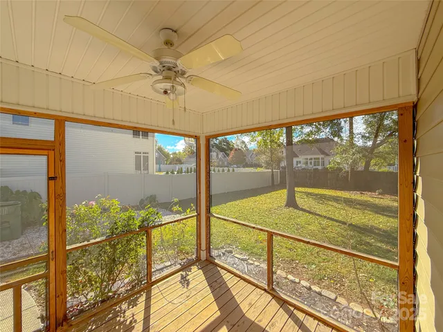 a view of a room with a floor to ceiling window next to a yard