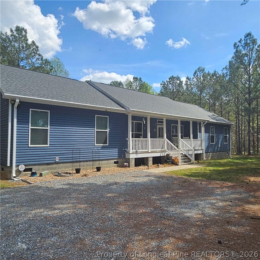 951 Lucian Hilliard Road Goldston, NC 27252 - Photo 1 of 25 a front view of a house with a yard and trees