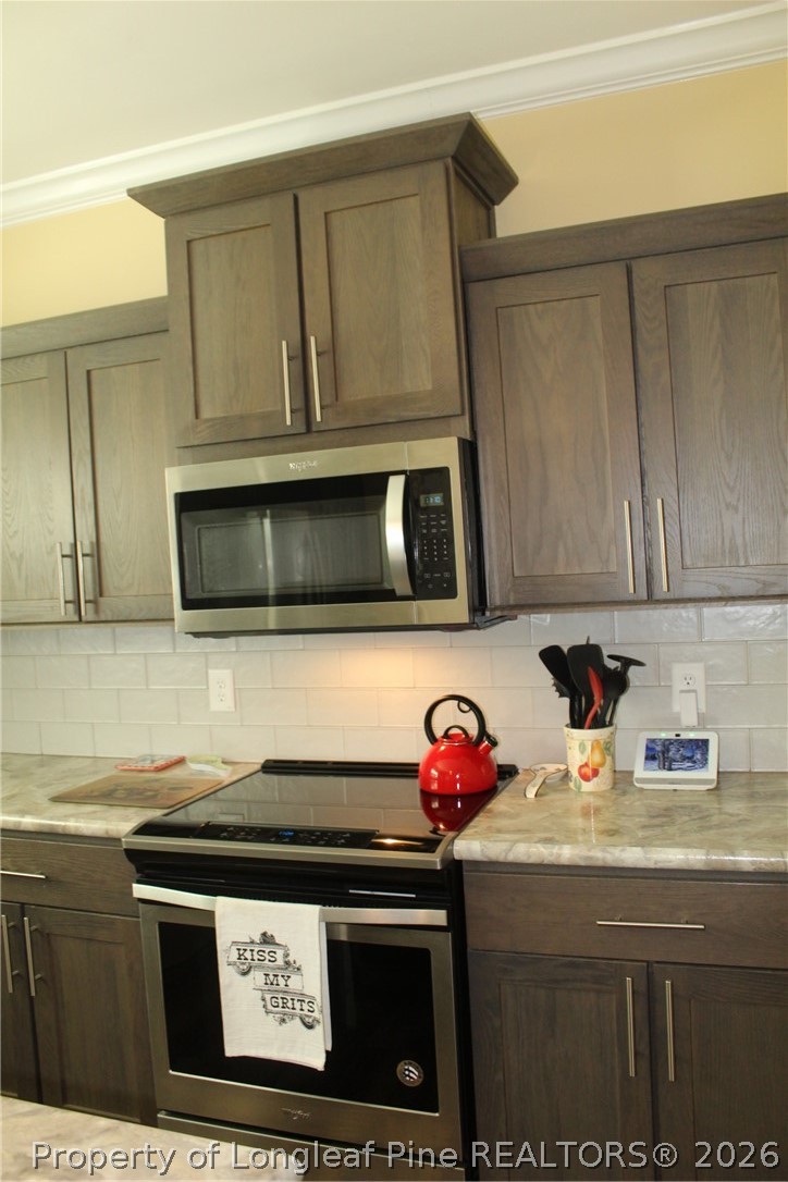 951 Lucian Hilliard Road Goldston, NC 27252 - Photo 6 of 25 a kitchen with a stove and a microwave
