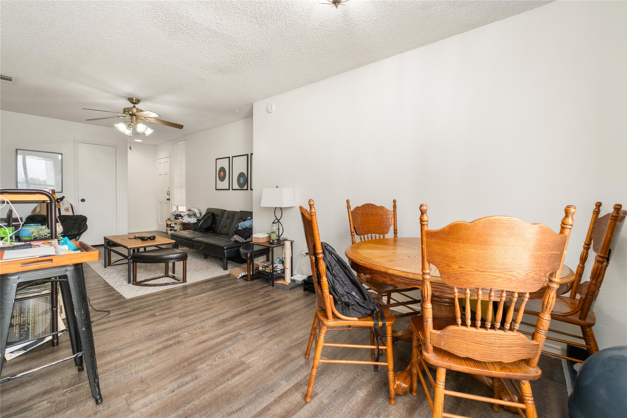 2409 Leon Street, Unit 307 Austin, TX 78705 - Photo 8 of 23 a living room with furniture a fireplace and a chandelier