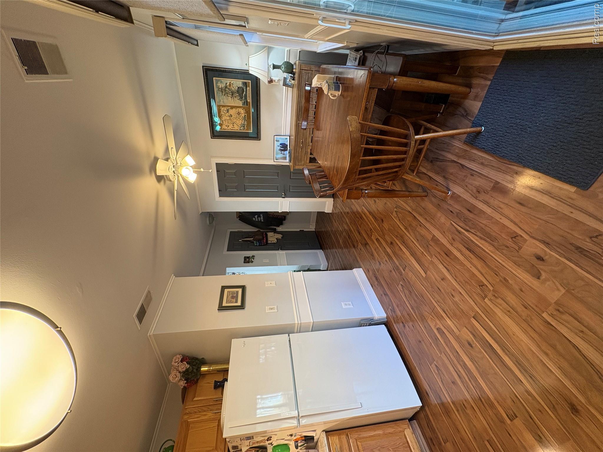 1030 Larson Court Rochester, MI 48307 - Photo 5 of 21 Dining room with dark wood finished floors, crown molding, and ceiling fan