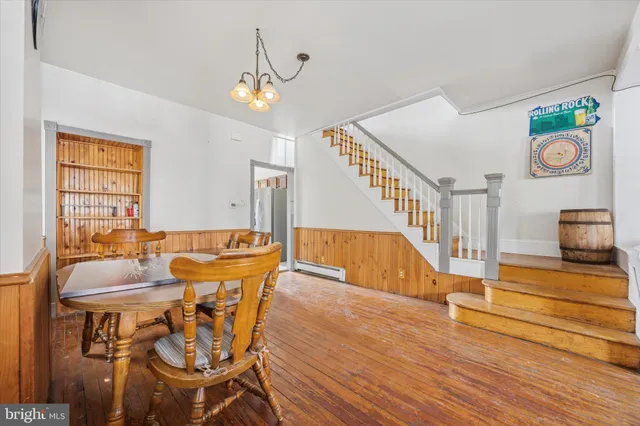 a view of a dining room with furniture a chandelier and wooden floor