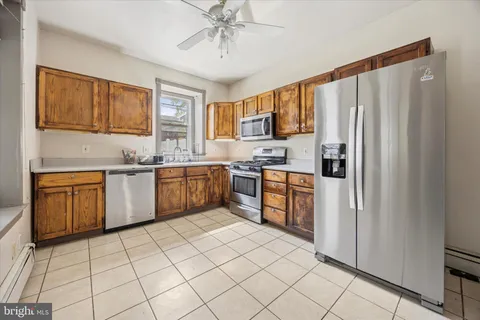 a kitchen with stainless steel appliances a sink window and cabinets