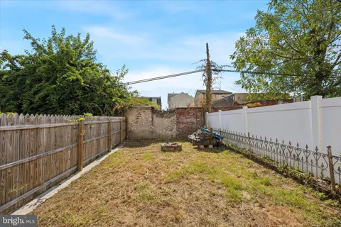 a backyard of a house with a tree