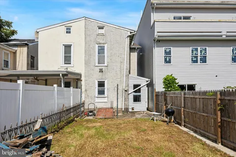 a view of a house with wooden fence