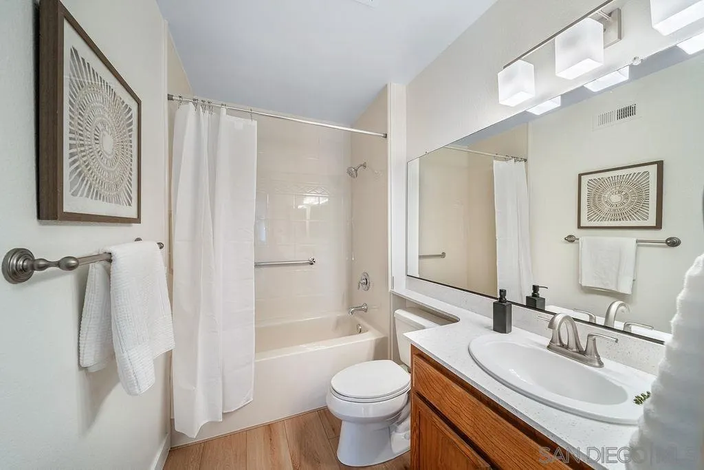 13489 Ridley Road San Diego, CA 92129 - Photo 21 of 36 a bathroom with a granite countertop toilet a sink and a mirror