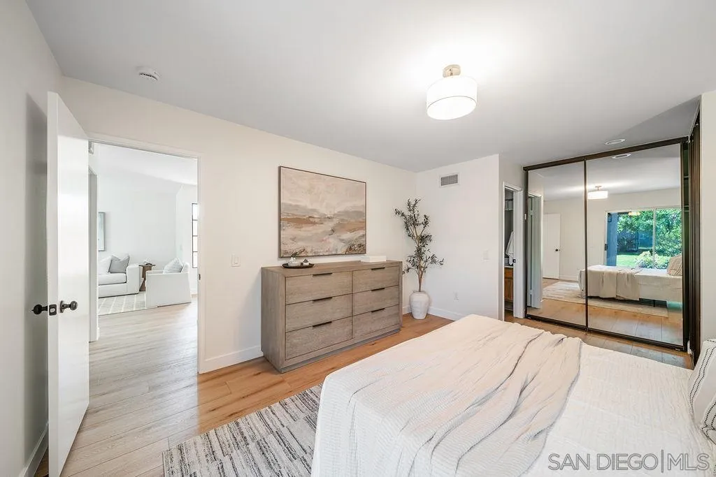 13489 Ridley Road San Diego, CA 92129 - Photo 23 of 36 a bedroom with a bed and a dresser next to a window