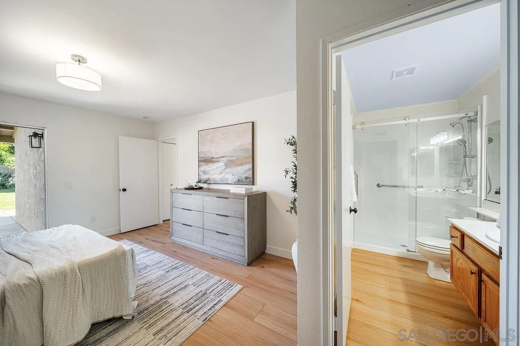 13489 Ridley Road San Diego, CA 92129 - Photo 26 of 36 a bedroom with a bed and a view of bathroom