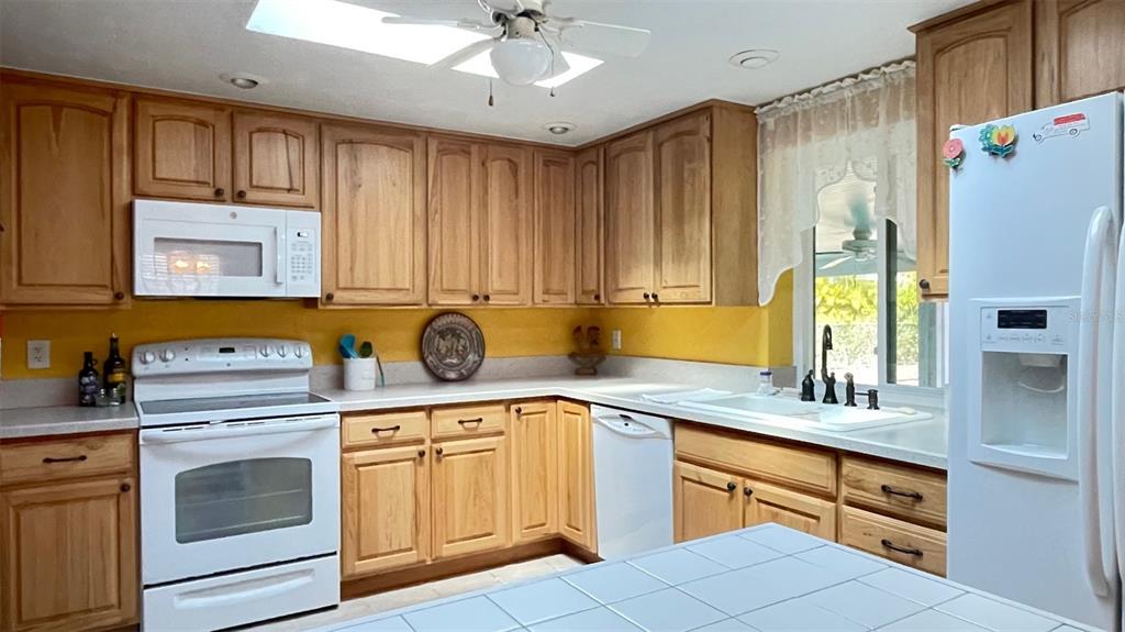 2233 Alice Road Sarasota, FL 34231 - Photo 12 of 30 a kitchen with stainless steel appliances granite countertop a sink a stove a refrigerator and cabinets