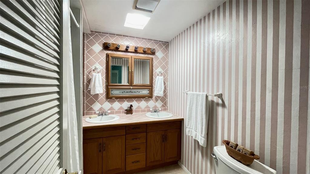 2233 Alice Road Sarasota, FL 34231 - Photo 18 of 30 a bathroom with a sink and a mirror
