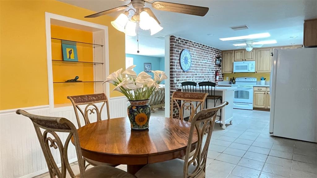2233 Alice Road Sarasota, FL 34231 - Photo 7 of 30 a dining room filled chandelier and wooden floor