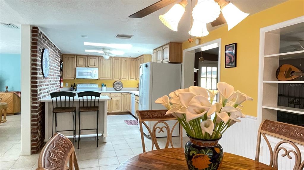 2233 Alice Road Sarasota, FL 34231 - Photo 9 of 30 a view of a dining room with furniture and a kitchen