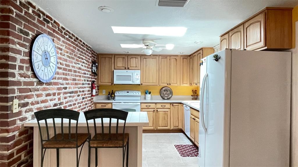 2233 Alice Road Sarasota, FL 34231 - Photo 10 of 30 a kitchen with stainless steel appliances granite countertop a stove a sink dishwasher and cabinets with wooden floor