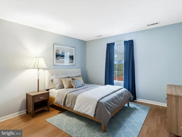 a bedroom with a bed and a night stand