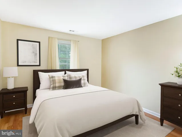 a bedroom with a bed and a night stand