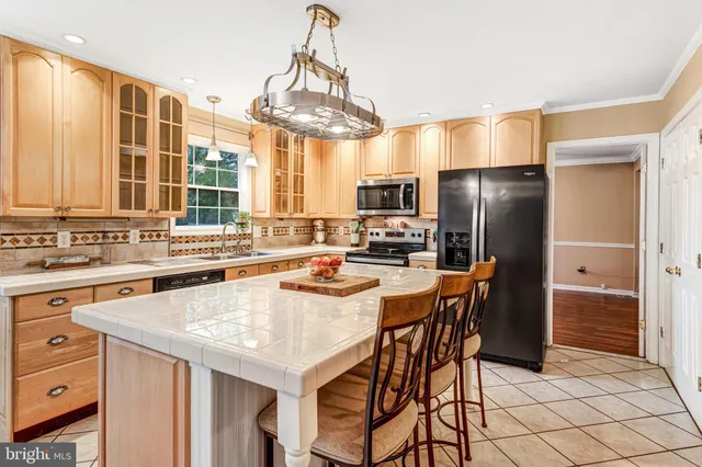a kitchen with stainless steel appliances a sink stove and refrigerator