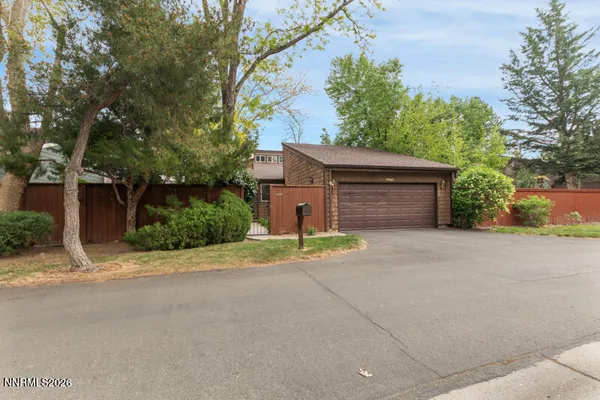 front view of a house with a yard and a garage