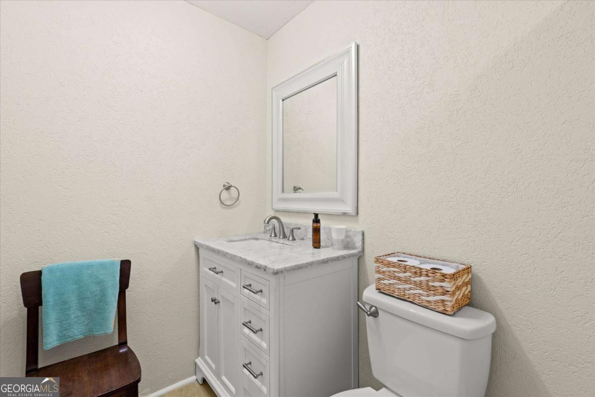 40-l Z L Z Jackson Road Bowdon, GA 30108 - Photo 15 of 32 a bathroom with a toilet sink and mirror
