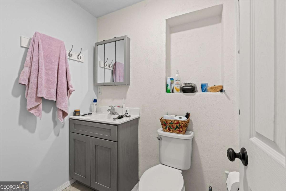 40-l Z L Z Jackson Road Bowdon, GA 30108 - Photo 19 of 32 a bathroom with a sink a toilet and a shower curtain