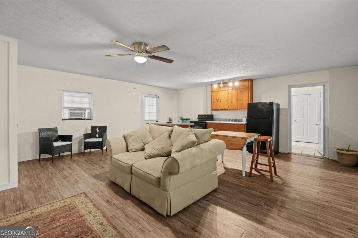 40-l Z L Z Jackson Road Bowdon, GA 30108 - Photo 21 of 32 a living room with furniture and wooden floor