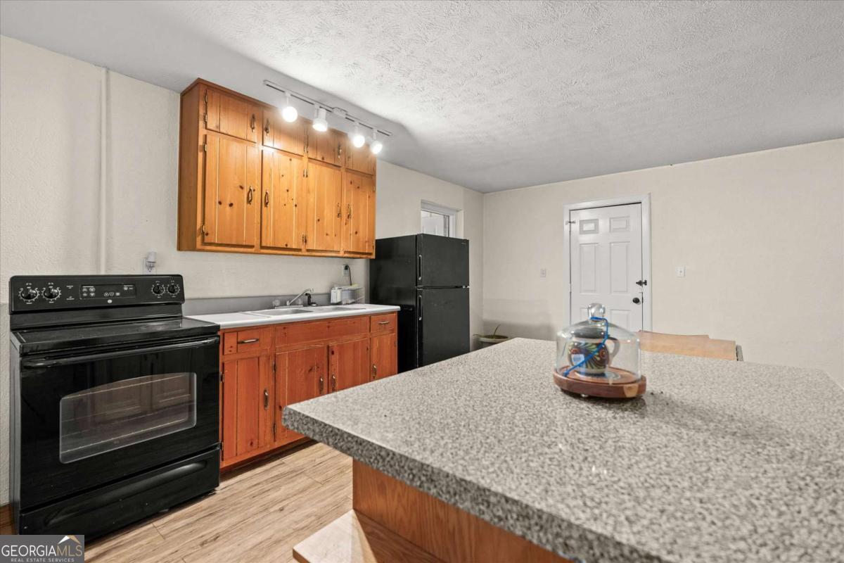 40-l Z L Z Jackson Road Bowdon, GA 30108 - Photo 23 of 32 a kitchen with stainless steel appliances granite countertop a stove a sink and a microwave