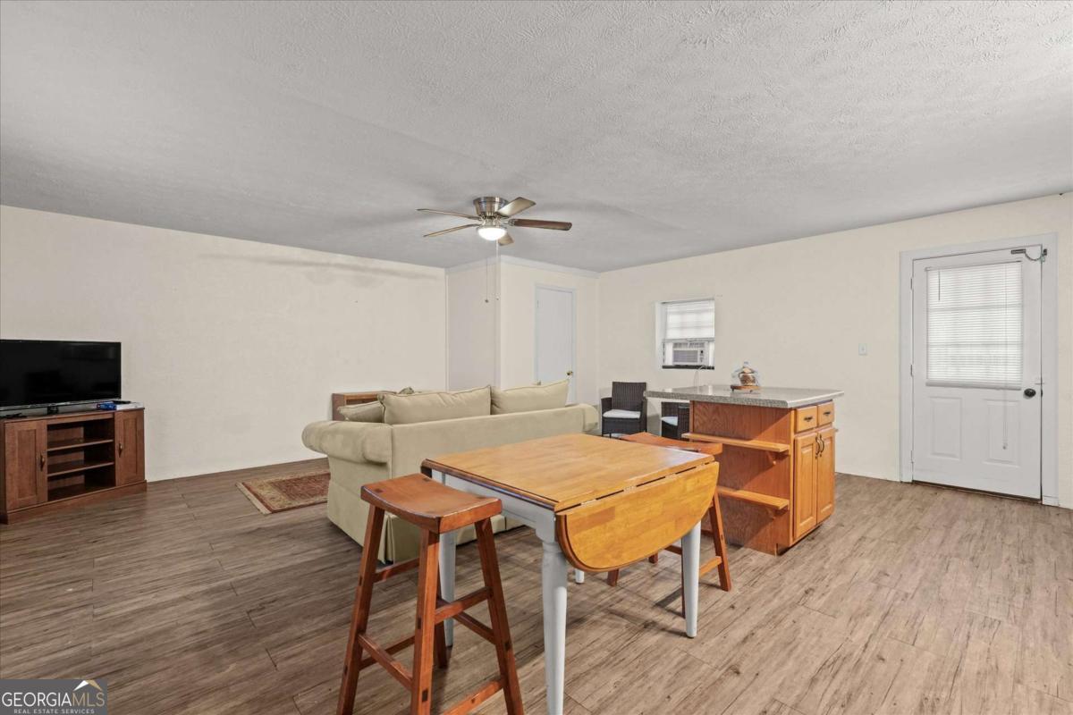 40-l Z L Z Jackson Road Bowdon, GA 30108 - Photo 24 of 32 a view of a dining room with furniture and wooden floor