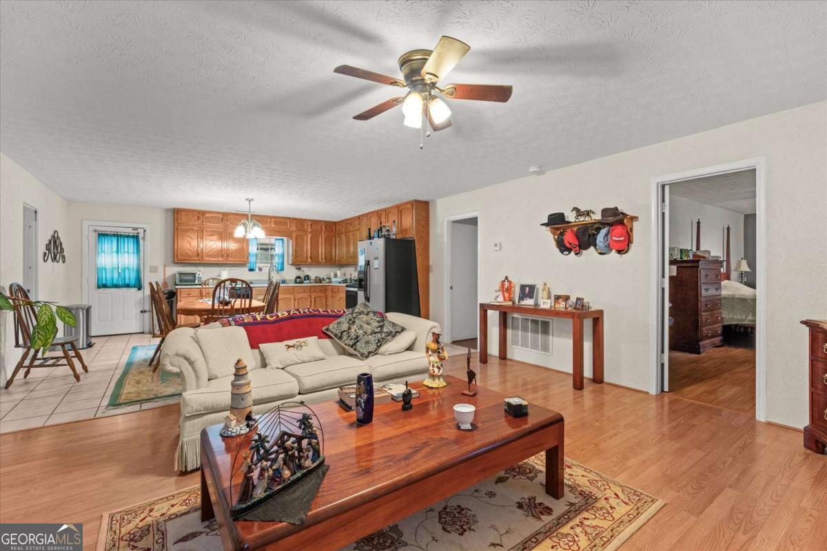 40-l Z L Z Jackson Road Bowdon, GA 30108 - Photo 6 of 32 a living room with furniture and wooden floor