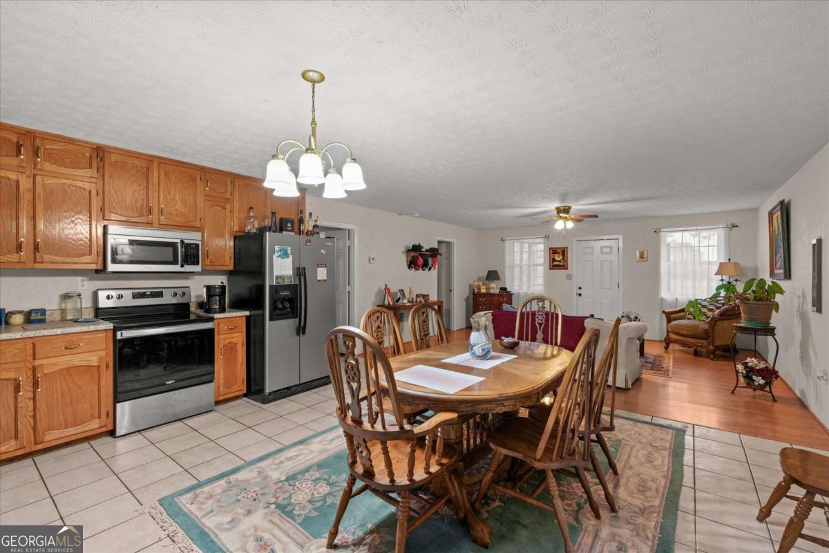40-l Z L Z Jackson Road Bowdon, GA 30108 - Photo 10 of 32 a view of a dining room with furniture a chandelier and wooden floor
