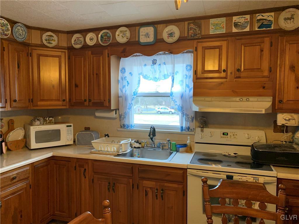 729 Bushkill Center Road Nazareth, PA 18064 - Photo 5 of 9 a kitchen with stainless steel appliances wooden cabinets and a sink