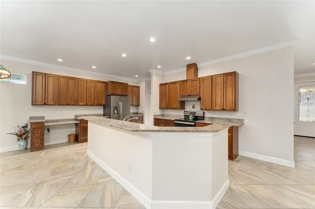 a kitchen with stainless steel appliances kitchen island granite countertop a sink and cabinets