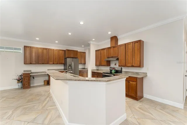 a kitchen with stainless steel appliances granite countertop a sink a stove and cabinets