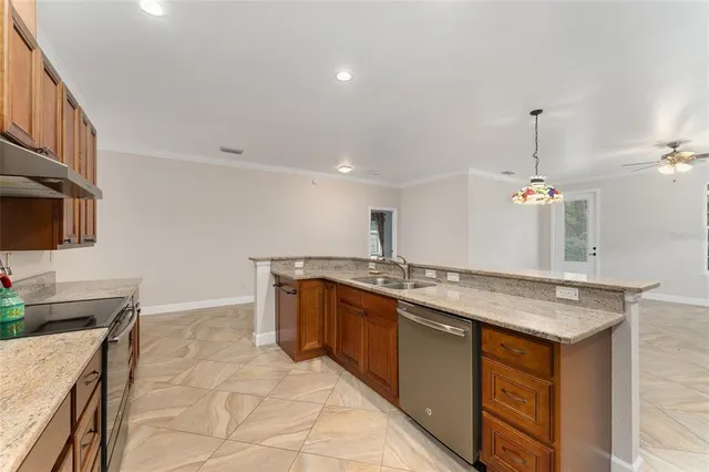 a kitchen with stainless steel appliances granite countertop a sink and a stove