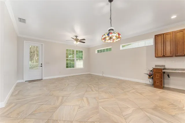 a view of an empty room with window and cabinet