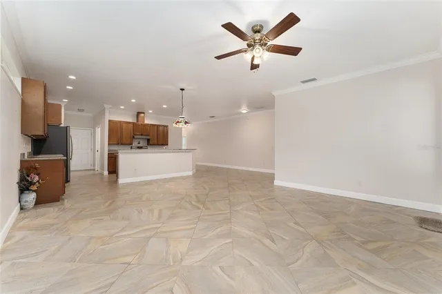 a view of a kitchen with a sink and a refrigerator