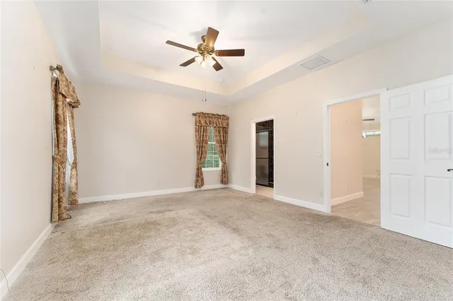 a view of an empty room with a ceiling fan