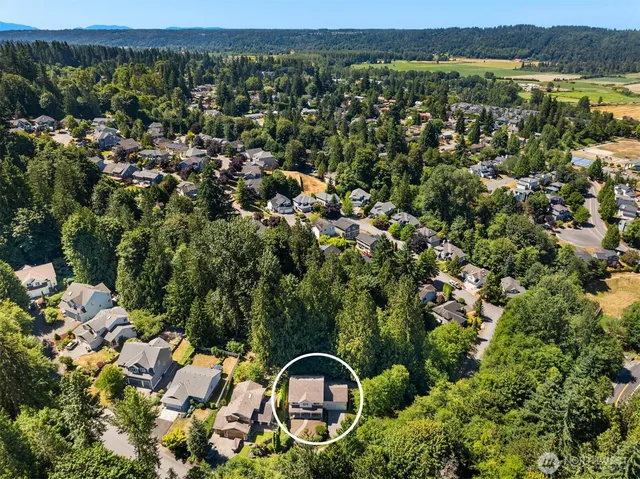 a kitchen with stainless steel appliances granite countertop a stove a sink dishwasher a refrigerator with a dining table and chairs