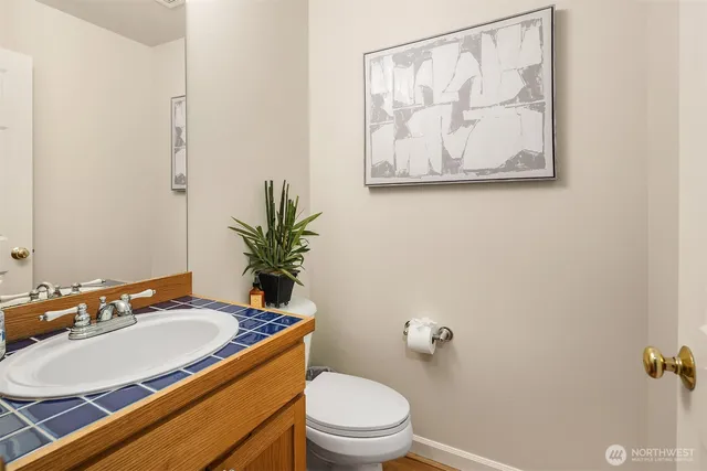 a spacious bathroom with a granite countertop sink mirror and a bathtub