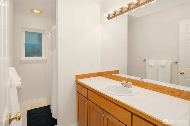 a front view of house with yard and trees in the background