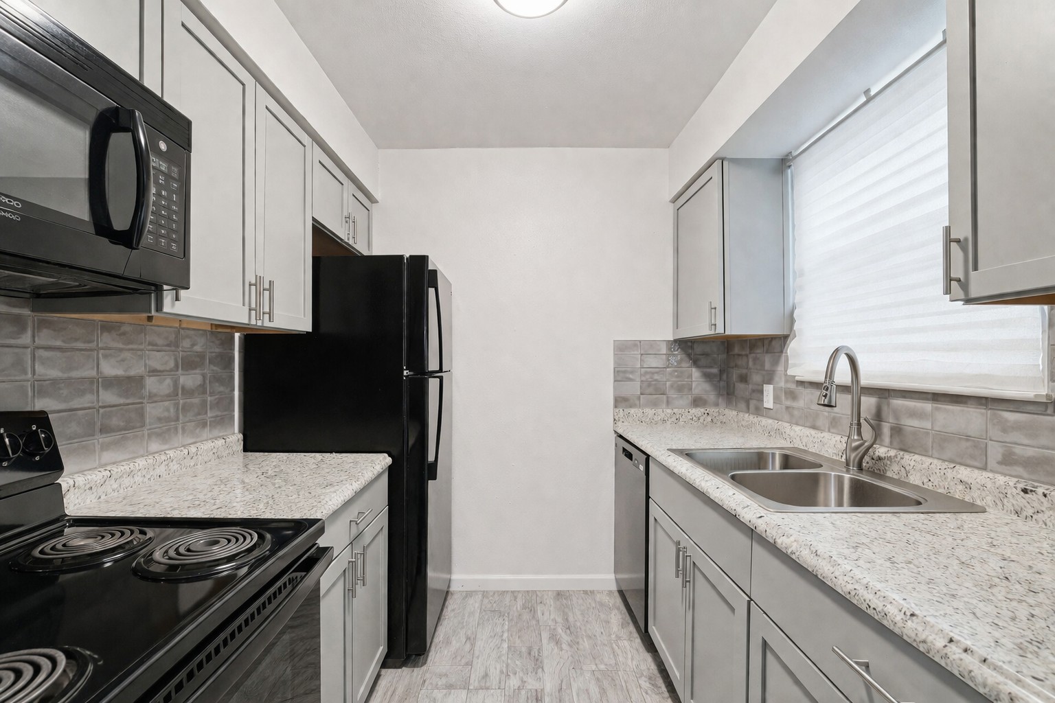 200 Monterrey Street, Unit A & B Elgin, TX 78621 - Photo 12 of 32 Galley kitchen with updated countertops and backsplash. 200 Monterrey, Elgin, TX 78621