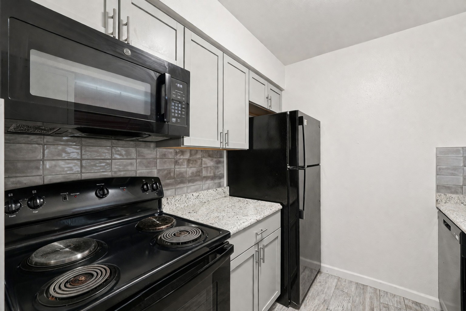 200 Monterrey Street, Unit A & B Elgin, TX 78621 - Photo 13 of 32 Galley kitchen with updated countertops andn backsplash. 200 Monterrey, Elgin, TX 78621