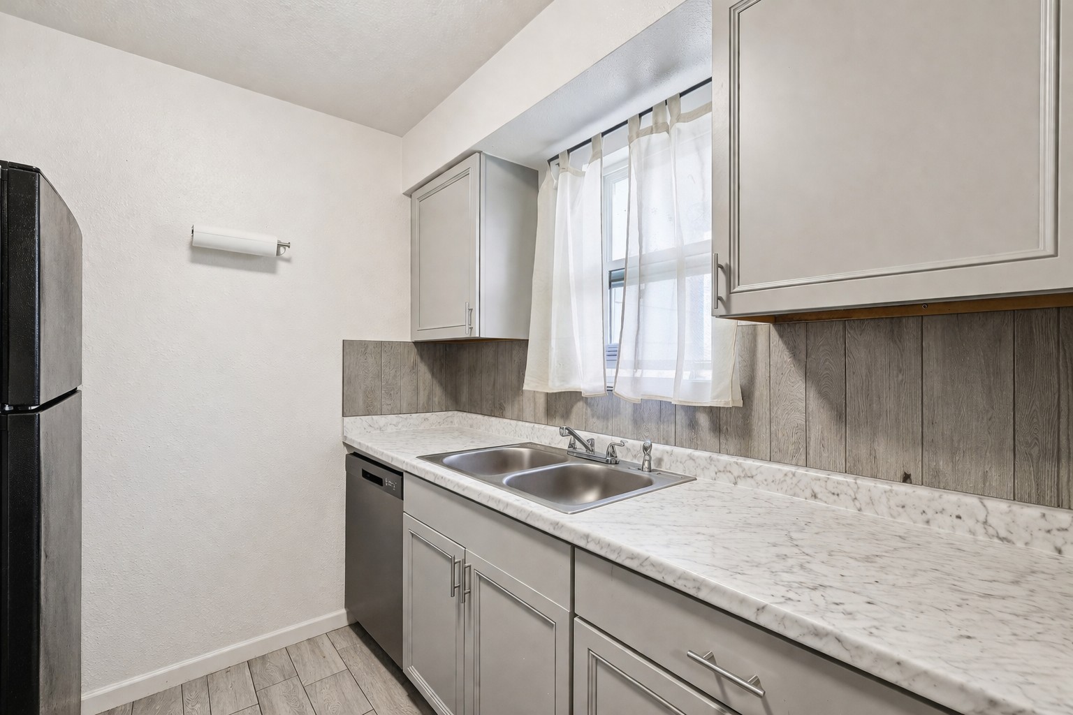 200 Monterrey Street, Unit A & B Elgin, TX 78621 - Photo 15 of 32 Galley kitchen with updated countertops and backsplash. 200 Monterrey, Elgin, TX 78621