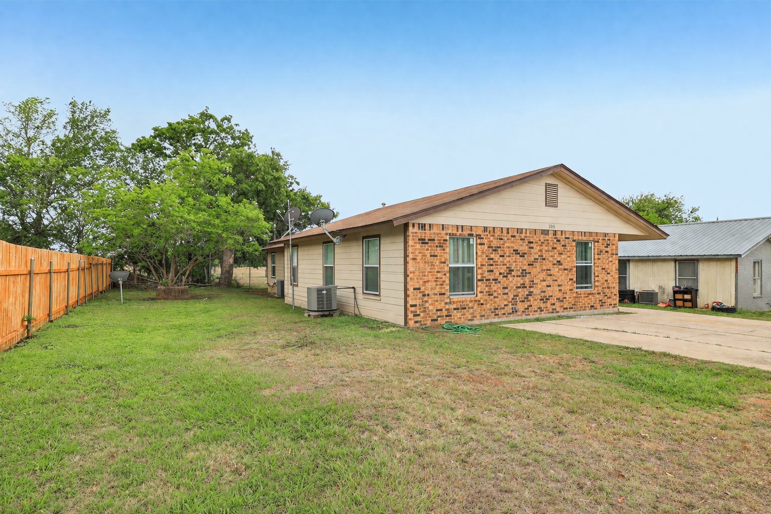 200 Monterrey Street, Unit A & B Elgin, TX 78621 - Photo 28 of 32 Side of duplex featuring the side yard - In-unit washer-dryer hookup - Bedroom - 200 Monterrey, Elgin, TX 78621