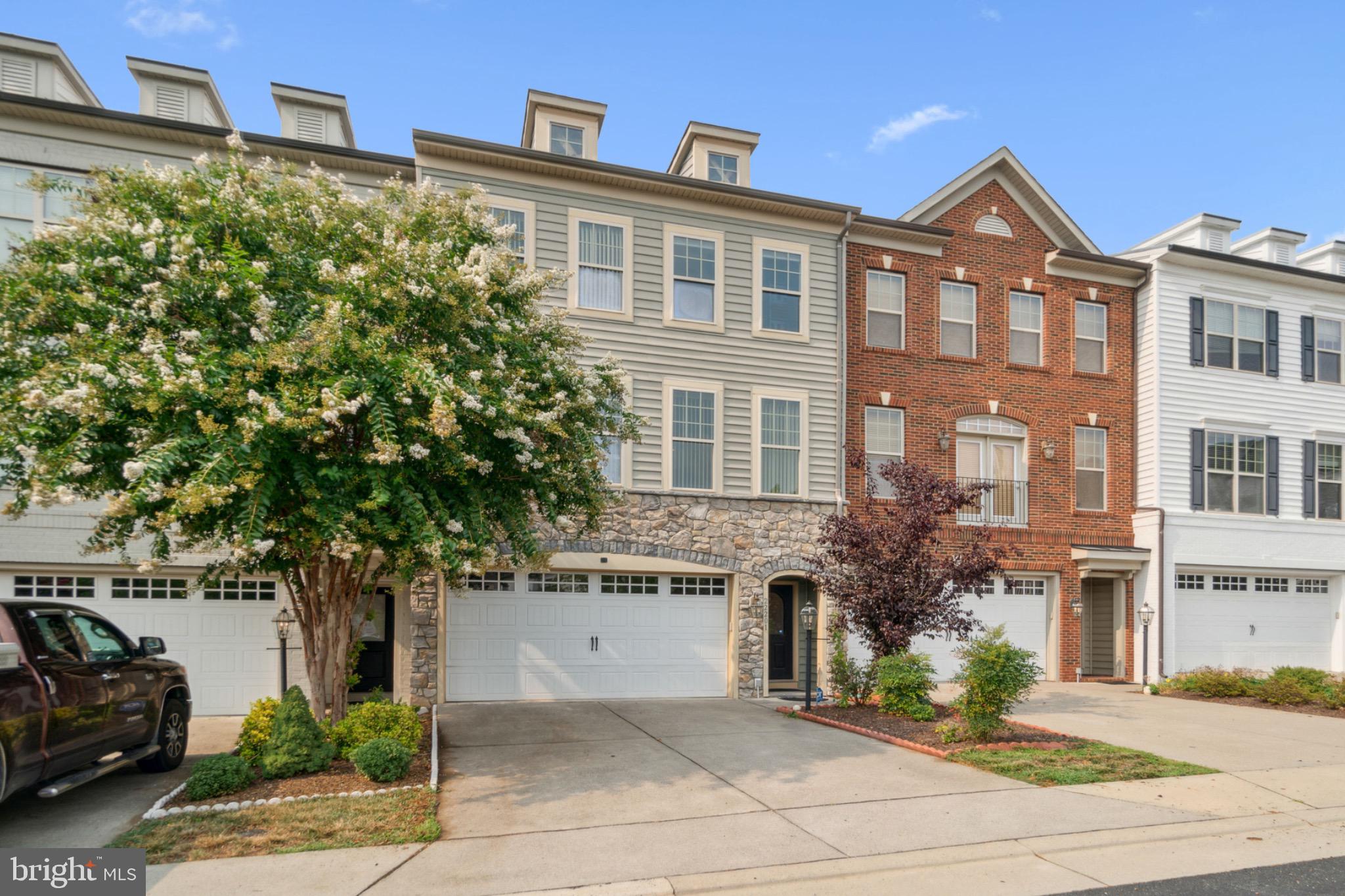 22201 Falling Terrace Ashburn, VA 20148 - Photo 3 of 26 Charming townhomes with lush landscaping.