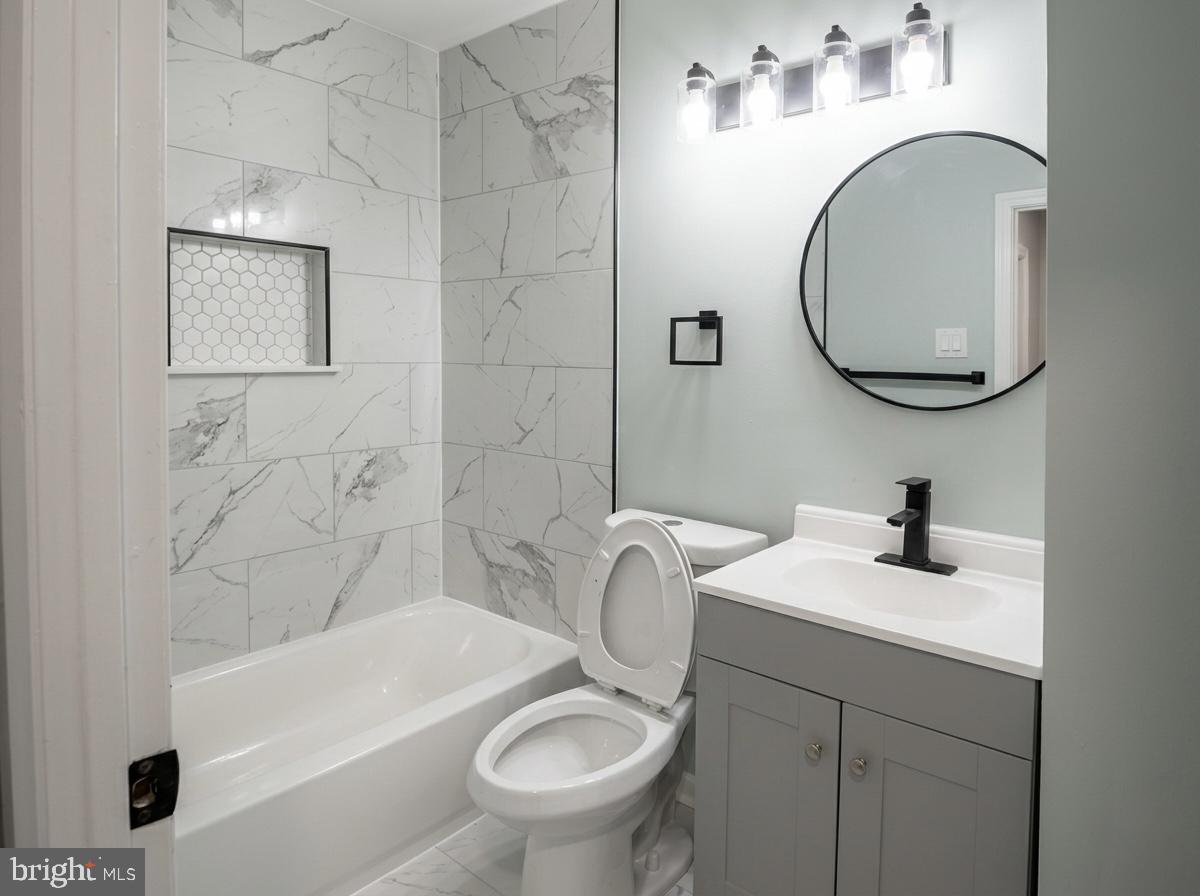 21 Neves Court Baltimore, MD 21234 - Photo 12 of 23 a bathroom with a sink a toilet and a mirror