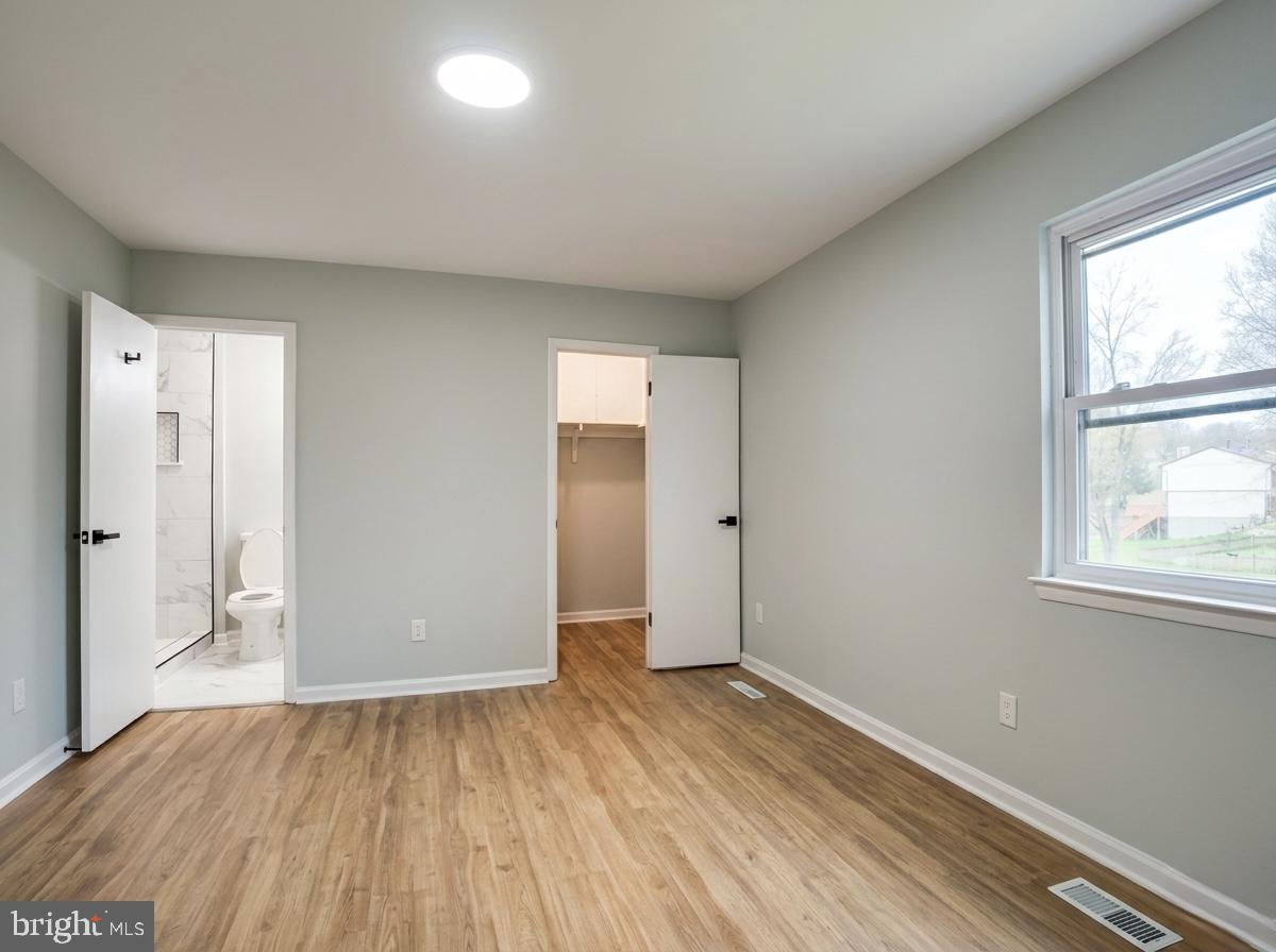 21 Neves Court Baltimore, MD 21234 - Photo 17 of 23 an empty room with wooden floor and windows