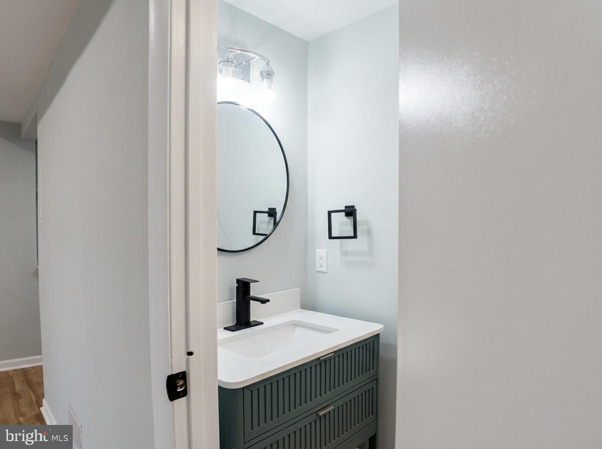 21 Neves Court Baltimore, MD 21234 - Photo 22 of 23 a bathroom with a sink and a mirror