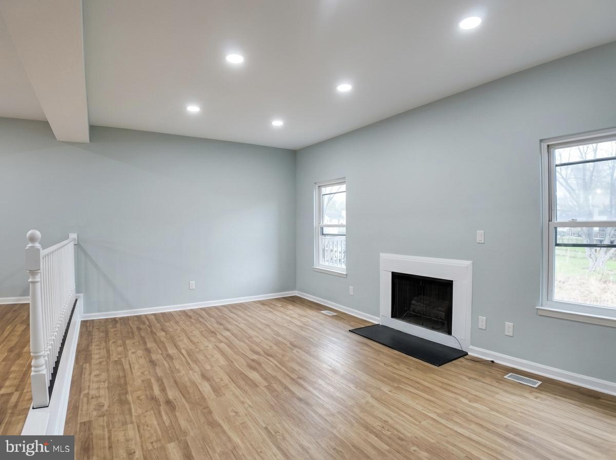 21 Neves Court Baltimore, MD 21234 - Photo 4 of 23 an empty room with windows and fireplace