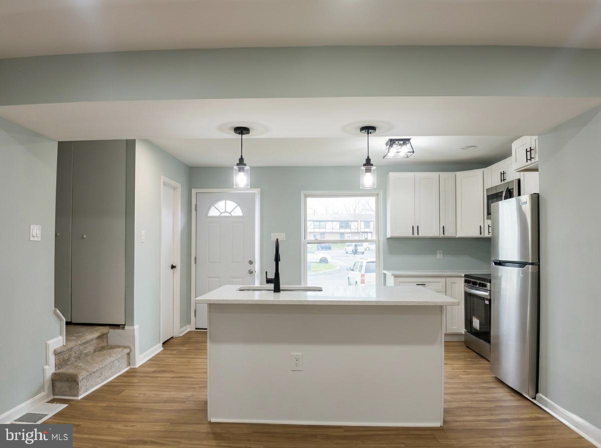 21 Neves Court Baltimore, MD 21234 - Photo 8 of 23 a large kitchen with kitchen island a sink stainless steel appliances and cabinets