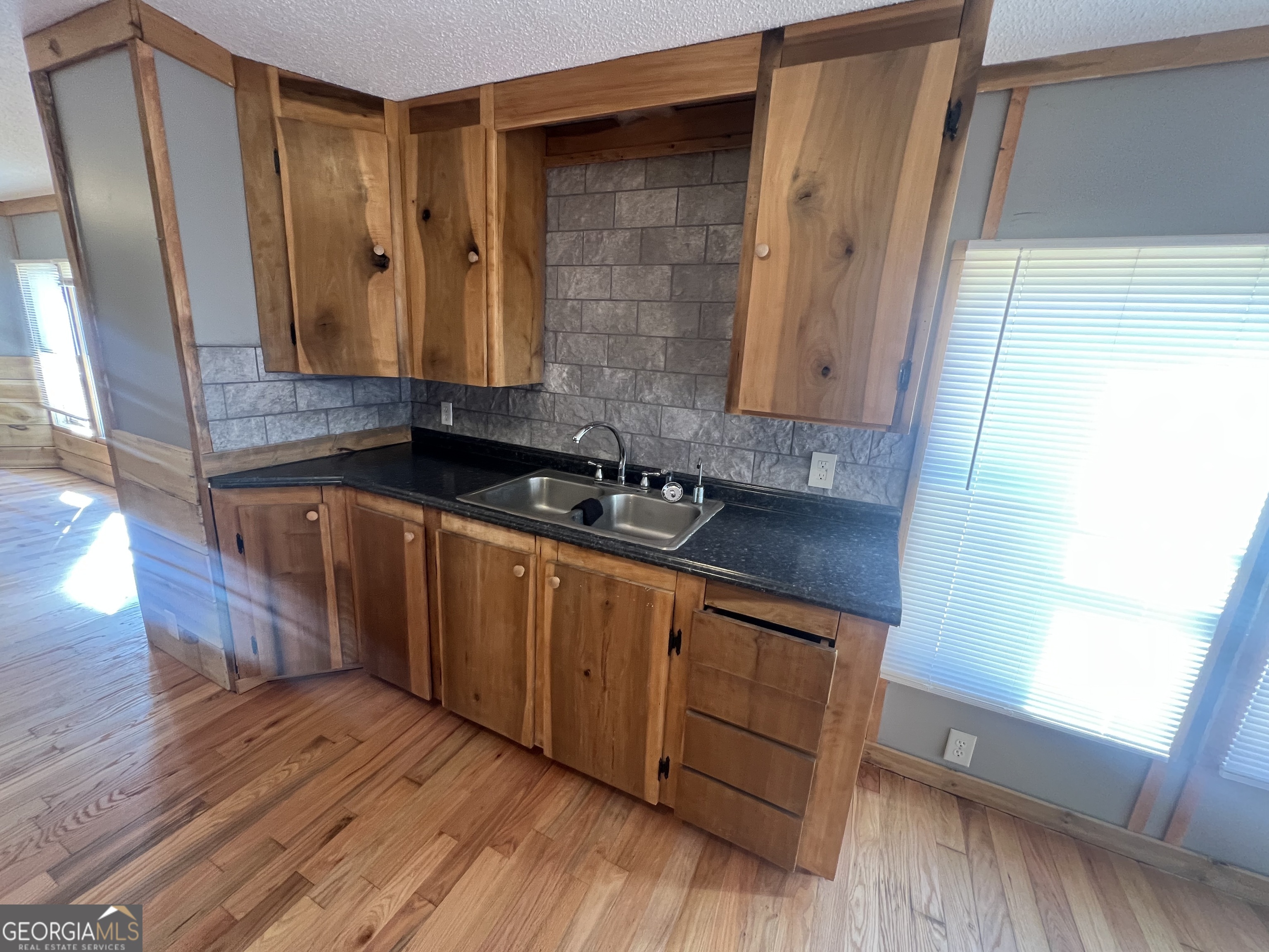 1425 Dowdy Road Roopville, GA 30170 - Photo 12 of 31 a kitchen with wooden floors and a sink